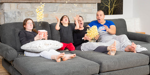 A family sitting on a couch in the basement