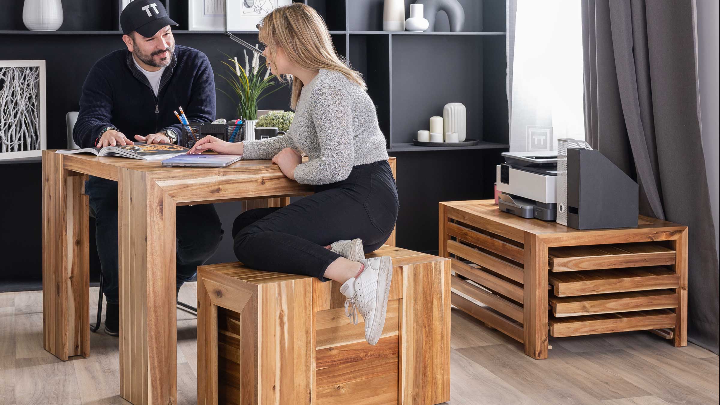 Two office co-workers sitting on modern office furniture.