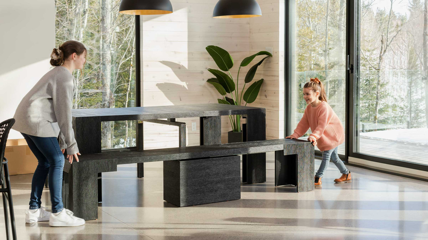 A mother and daughter moving a extendable dining table