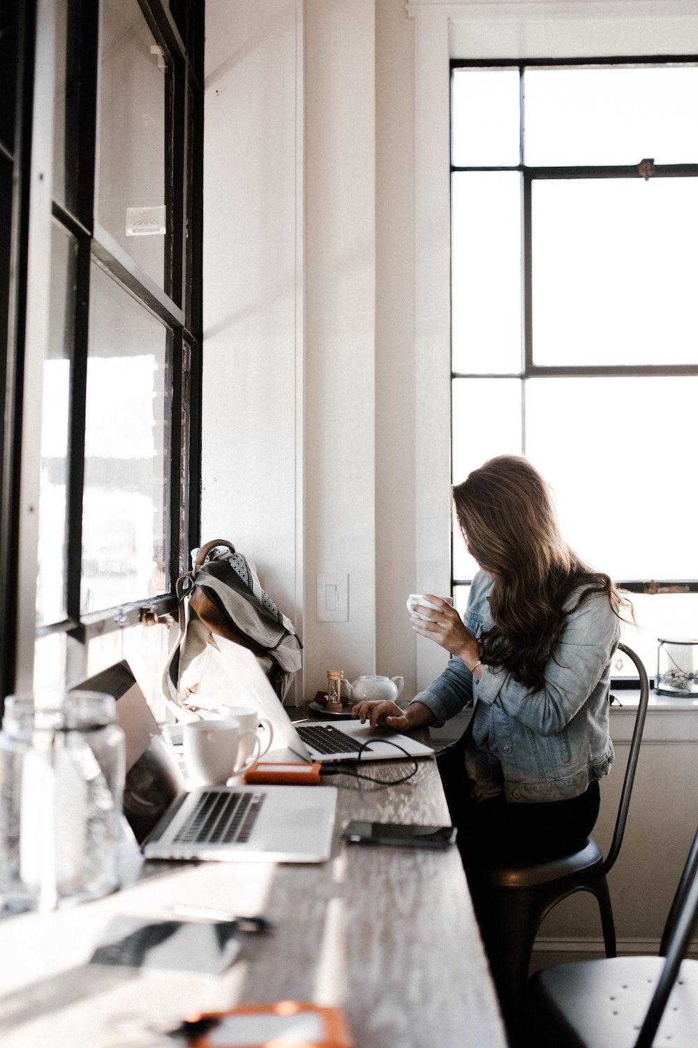 People working on their laptops at a modern work table.