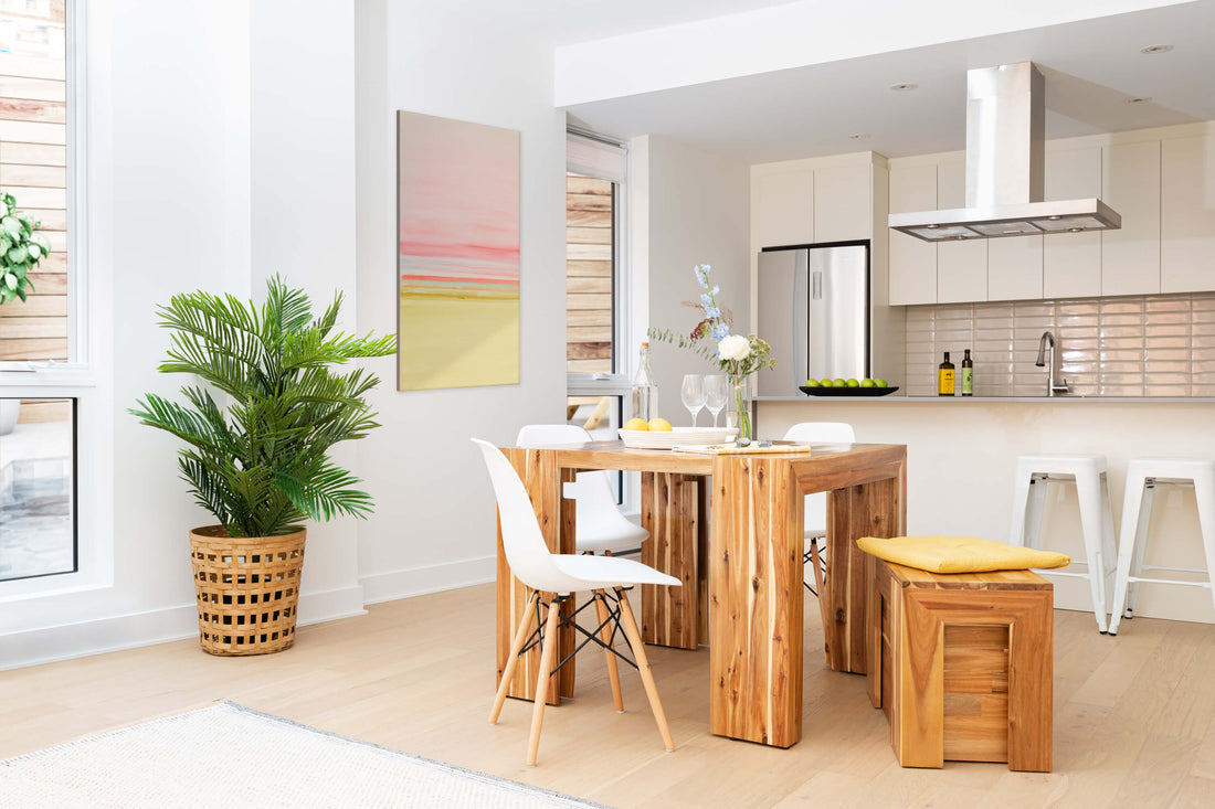 A modern kitchen table in a well lit kitchen.