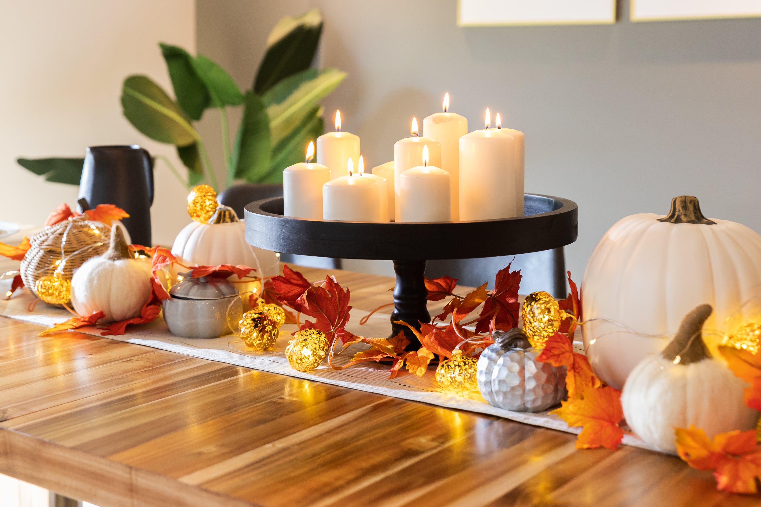 Our Australian Acacia Transformer Table is adorned with fall decor and pillar candles as a centrepiece. You can play with different candle heights to achieve a balanced display. 