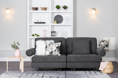 Dark coloured couch in front of a white display cabinet