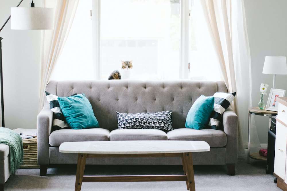 A modern couch and coffee table in a small living room.