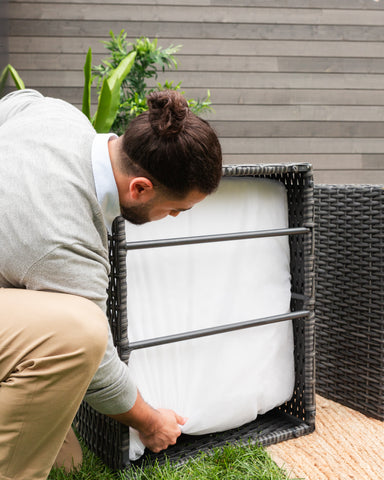 A man fixing wicker furniture