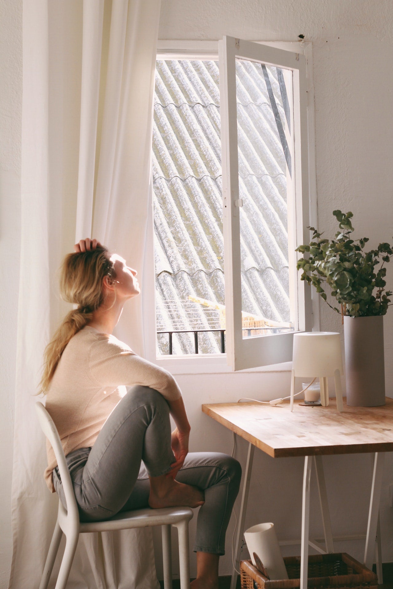 A lady sitting at a modern table.