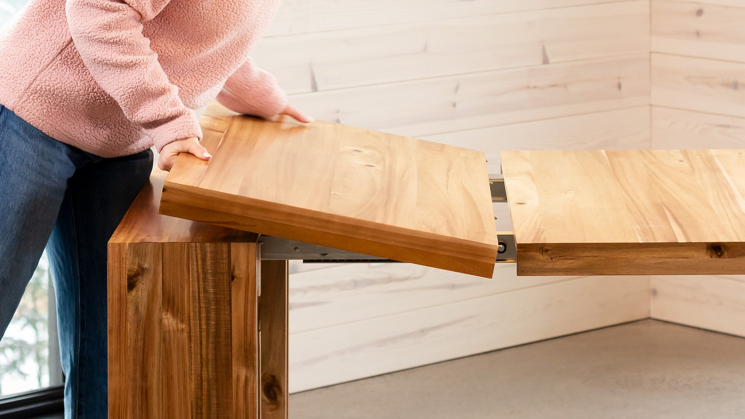 A lady adjusting her transformable table.