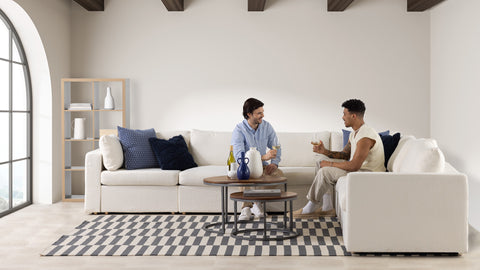 A family sitting on a sectional couch